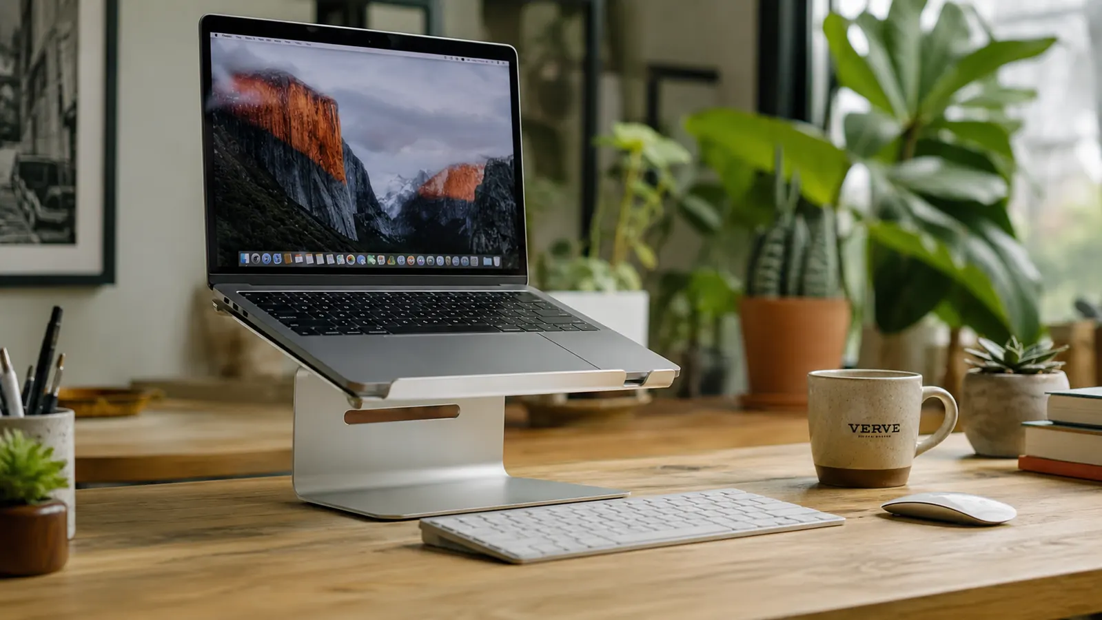 Silver aluminum BESIGN laptop stand and a broken white plastic laptop stand side by side on a wooden desk