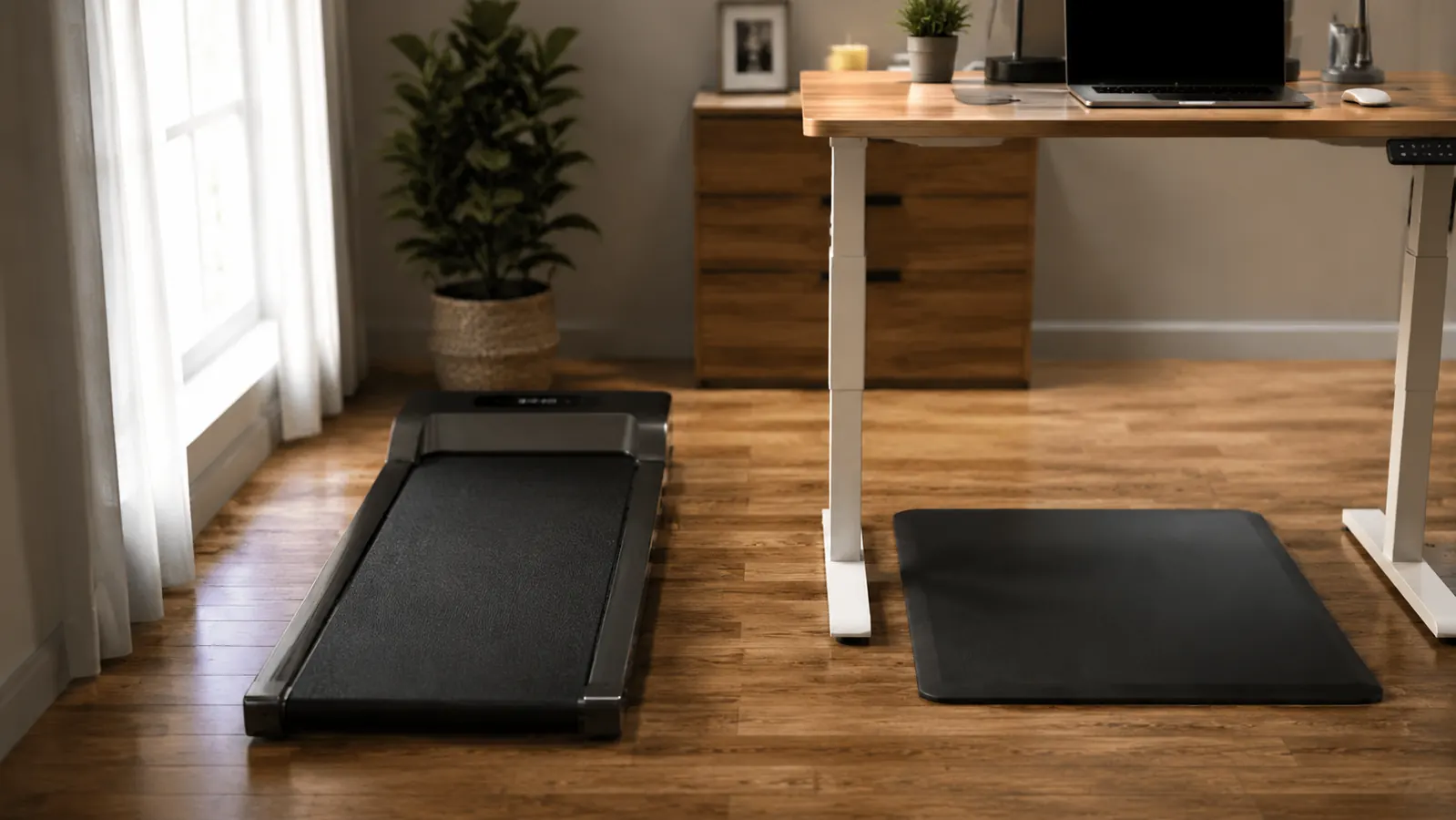 Home office desk with walking pad treadmill beneath it and a person typing while walking slowly